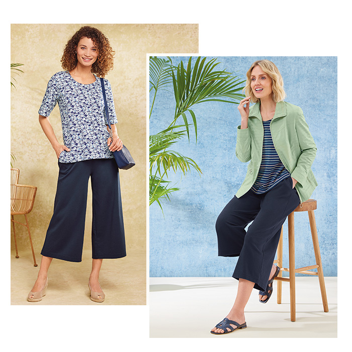 Two images of models wearing navy coloured culottes. One is wearing a pair of these wide leg cropped trousers with a blue and white floral T shirt and blue handbag. The other is wearing the pair of navy culottes with a navy and multi-coloured striped T-shirt and light green seasonal coat. 