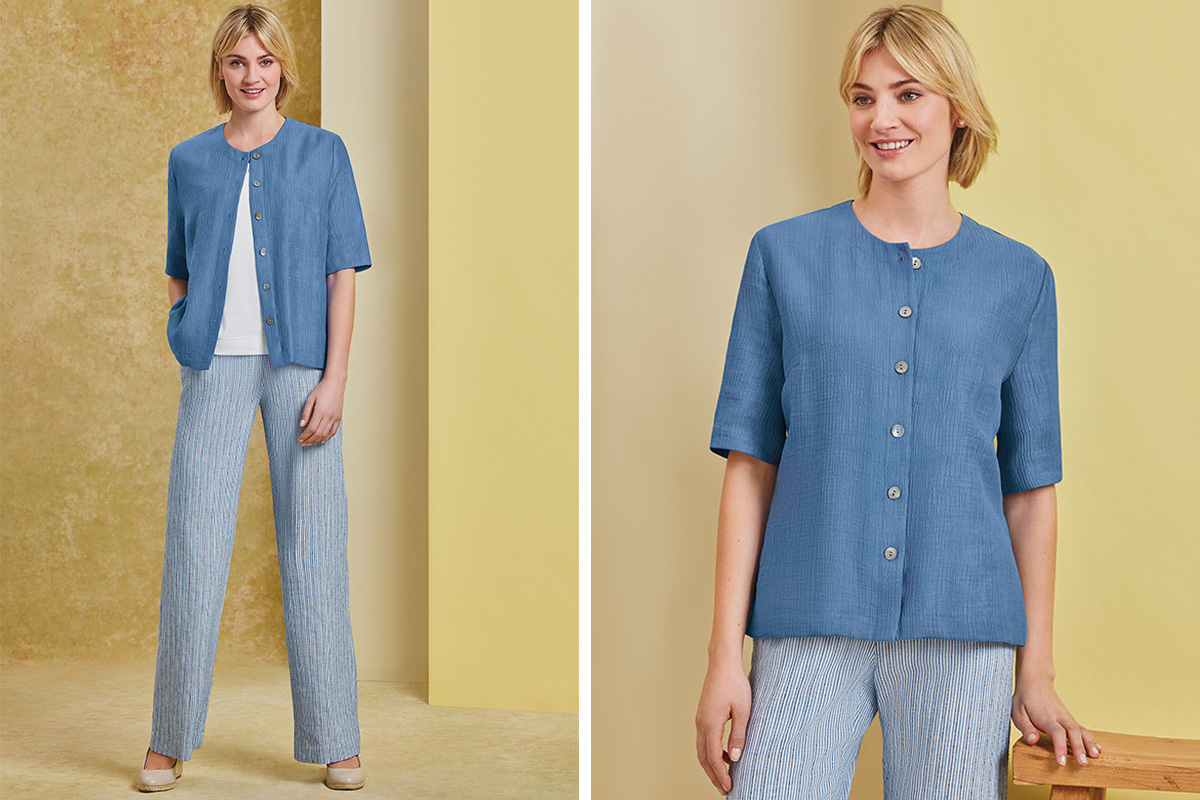 a short sleeved blue textured blouse with a white t shirt and striped wide leg trousers. 